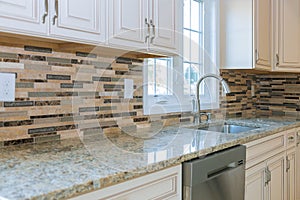 Interior of modern kitchen with appliances on stove top, marble counter with kitchen white cabinets