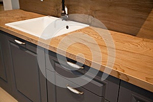 Interior of modern kitchen and ceramic sink and tap