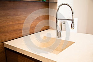 Interior of modern kitchen and ceramic sink and tap
