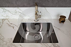 Interior of modern kitchen and ceramic sink and tap