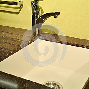 Interior of modern kitchen and ceramic sink and tap