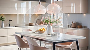 Interior of modern kitchen with dining table, chairs, and pink hanging chandeliers and flower vase.