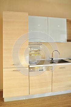 Interior of modern kitchen equipment, white and oak cabinets