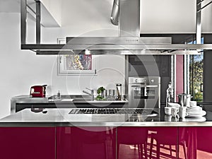 Interior of a modern kitchen in the foreground the isalnd kitchen
