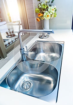 Interior of modern kitchen with stanless steel sink
