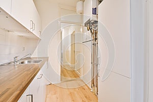 Interior of modern kitchen with white furniture