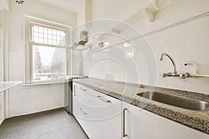 Interior of modern kitchen with white furniture