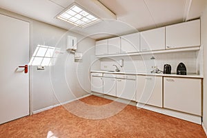 Interior of modern kitchen with white furniture
