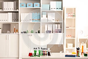 Interior of modern laboratory with chemical glassware on table