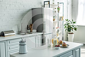 interior of modern light kitchen with fridge