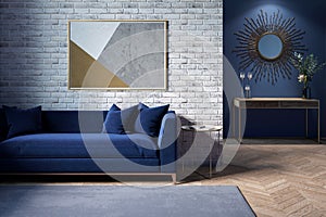 The interior of a modern living room with a dark blue sofa next to a brick wall on which a horizontal poster hangs.