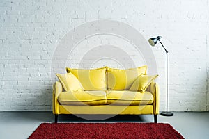 Interior of modern living room with rug, couch and floor