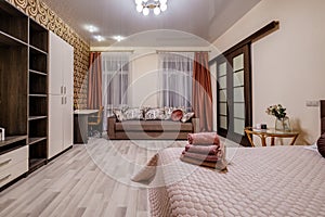 Interior of modern luxure bedroom in studio apartments in light pink color style