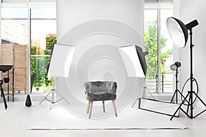 Interior of modern photo studio with armchair