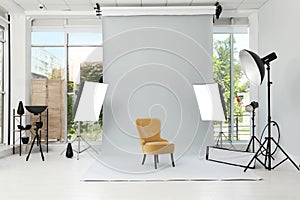 Interior of modern photo studio with armchair