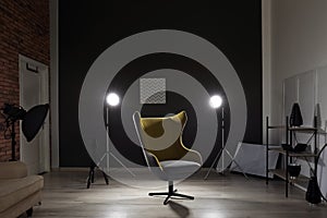 Interior of modern photo studio with armchair