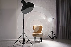 Interior of modern photo studio with professional lighting equipment