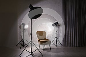 Interior of modern photo studio with professional lighting equipment