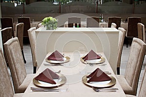 Interior of modern restaurant with served table