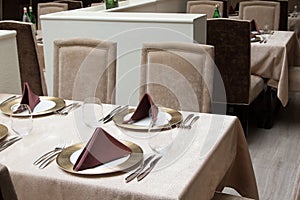 Interior of modern restaurant with served table