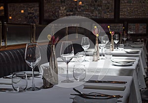 Interior of a modern restaurant with tables served for dinner