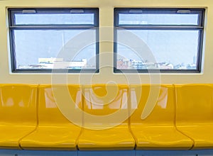 Interior of a modern subway car , sky train yellow seat