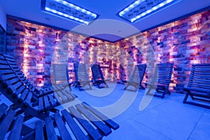 interior of modern wellness salt haloper cave with uv light with wooden bench