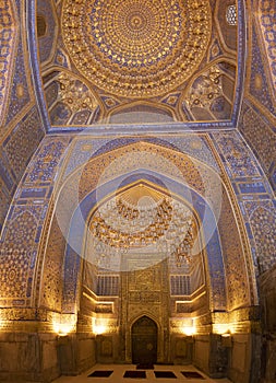 Interior of mosque dome with gold gild of Tile Karl Madrasa in T