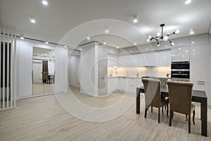 Interior of new spacious white kitchen after renovation in studio apartmen