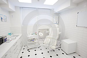 Interior of office of podiatrist, master of medical pedicure and manicure. Beauty salon design in light colors.