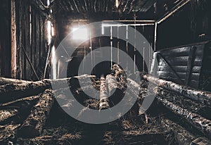 The interior of an old abandoned barn. Clutter, junk. Interesting lighting