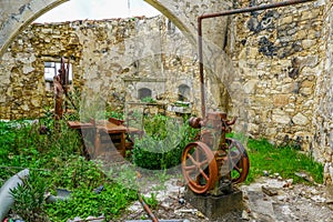 Interior of an old abandoned craft workshop with rusty workbenches