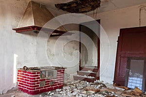 Interior of an old abandoned and uninhabited typical Friulian peasant house with economic kitchen.