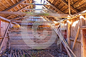 Interior of an old barn with a broken roof