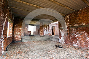 Interior of an old building under construction. Orange brick walls in a new house.