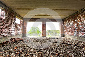 Interior of an old building under construction. Orange brick walls in a new house.