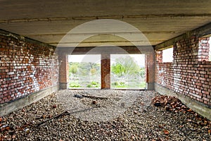 Interior of an old building under construction. Orange brick walls in a new house.