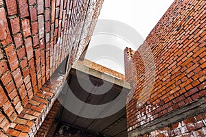 Interior of an old building under construction. Orange brick walls in a new house.