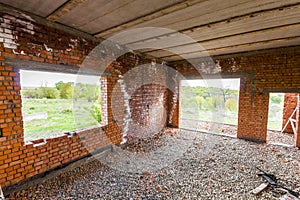 Interior of an old building under construction. Orange brick walls in a new house.