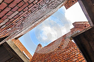 Interior of an old building under construction. Orange brick walls in a new house.