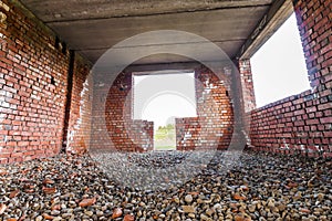 Interior of an old building under construction. Orange brick walls in a new house.