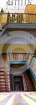 Interior of old renovated wooden square spiral staircase