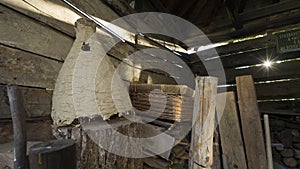 Interior of an old rustic wooden barn with a hive of wild bees, basket