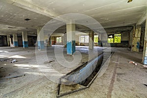 Interior of old warehouse building destroyed. Ruins of industrial enterprise, debris in abandoned factory premises as result of e