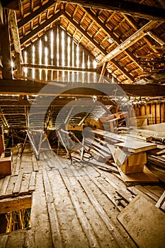 Interior of old wooden shed with scrap wood with sunrays