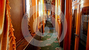 Interior of old wooden train wagon with wooden walls and carpets on floor