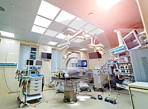 Interior of operating room in modern clinic, lamps and ultra modern devices, technology in modern clinic.