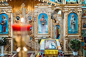 Interior of an Orthodox Ukrainian church. Iconostasis, altar. Blurred burning candle
