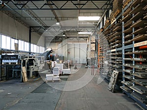 Interior of a paper and cardboard factory, die-cutting department. Packaging.