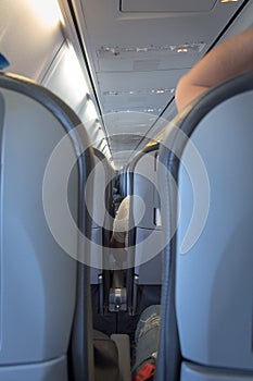 Interior of passenger airplane with people on seats